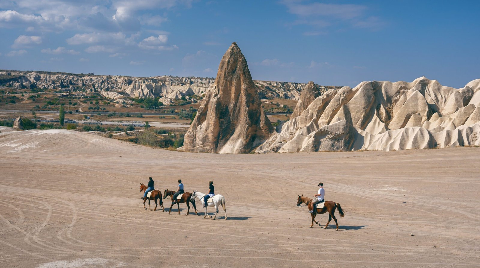 Tourists enjoy ride horses in Cappadocia, Turkey